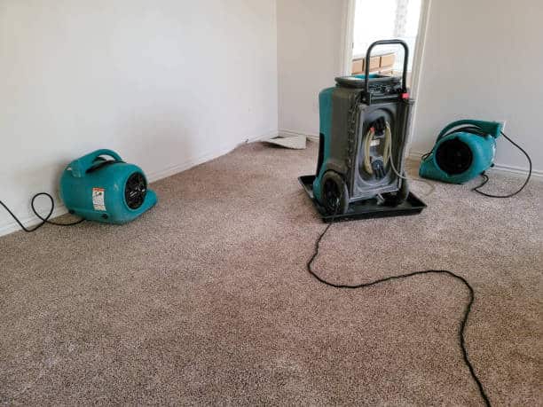 Two air movers and a dehumidifier drying a home. ORLANDO FLORIDA AFFORDABLE WATER DAMAGE COMPANIES